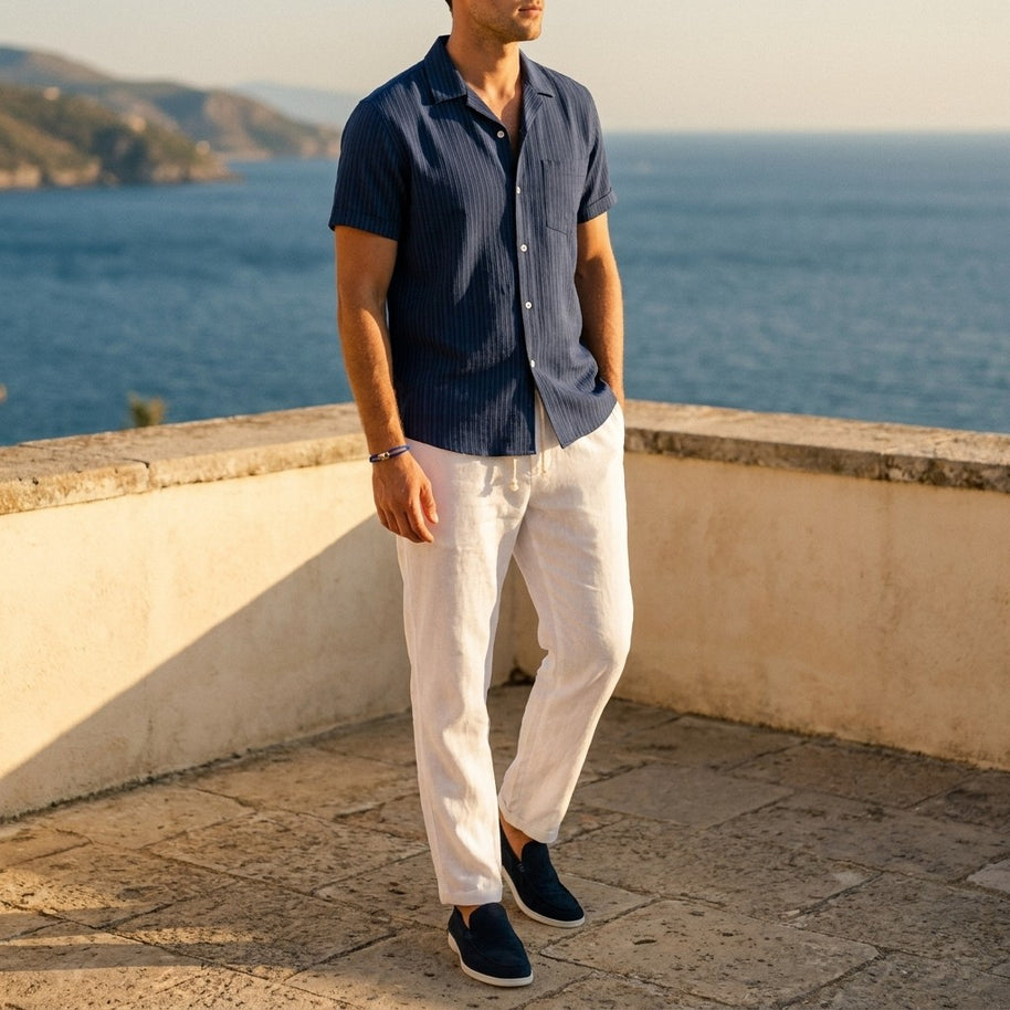 Man wearing the Navy four-piece set on a Mediterranean terrace
