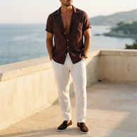 Man wearing the Chestnut four-piece set on a Mediterranean terrace