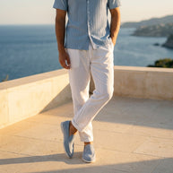 Man wearing the Looksmaxxing Coastal Light Blue outfit set on a Mediterranean terrace