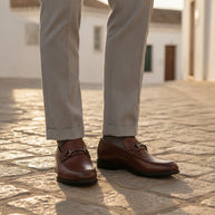 Man wearing the Looksmaxxing Bari elevator slip-on on a Mediterranean street