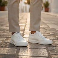Man wearing the Looksmaxxing Amalfi elevator trainers on a Mediterranean street