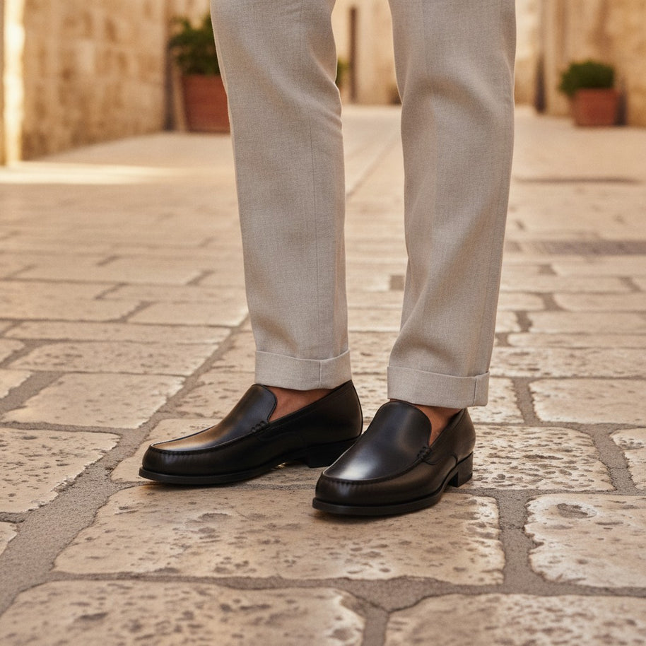 Man wearing the Looksmaxxing Como elevator loafer on a Mediterranean street