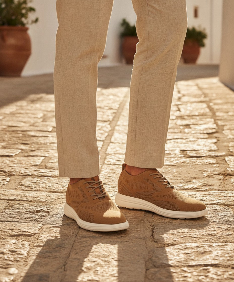 Man wearing the Looksmaxxing Capri elevator trainers on a Mediterranean street