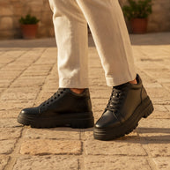 Man wearing the Looksmaxxing Stromboli platform trainers on a Mediterranean street